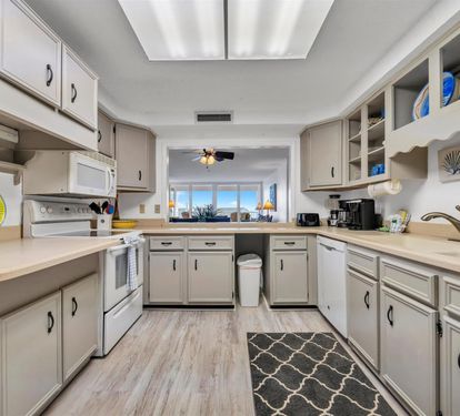 Your fully equipped kitchen features modern appliances and ample counter space, perfect for preparing meals while enjoying the coastal view.