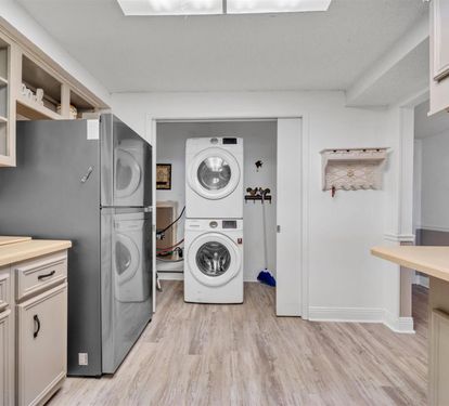 Your beautiful kitchen flows into a dedicated laundry room with modern appliances, making meal prep and cleanup effortlessly convenient.