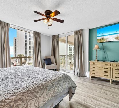Wake up to sunshine streaming through your private balcony as you enjoy ocean views from your coastal-themed bedroom retreat.