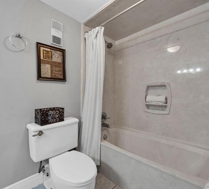 Enjoy a refreshing soak in your private tub-shower combo, complete with soft towels and thoughtful amenities for your comfort.