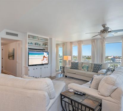 Relax in your bright living room with coastal views, plush seating, and entertainment center for perfect vacation evenings.