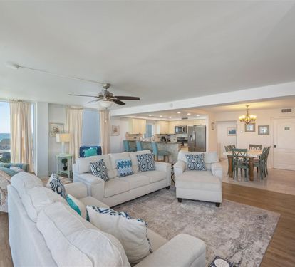 Relax in this bright, coastal-inspired living space where soft blues meet comfortable seating and stunning views.