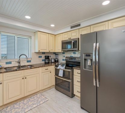 Prepare delicious meals in your fully equipped kitchen featuring stainless steel appliances, granite counters, and ample cabinet space.