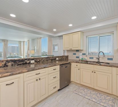 Your gourmet kitchen features granite countertops, modern appliances, and city views through large windows for memorable meal preparation.