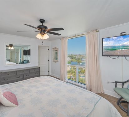 Drift off to sleep in your serene bedroom with stunning lake views, gentle ceiling fan, and cozy seating where you can unwind.
