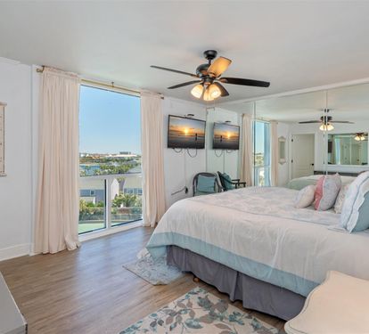 Drift off in your serene master suite with waterfront views and coastal breezes flowing through expansive windows.