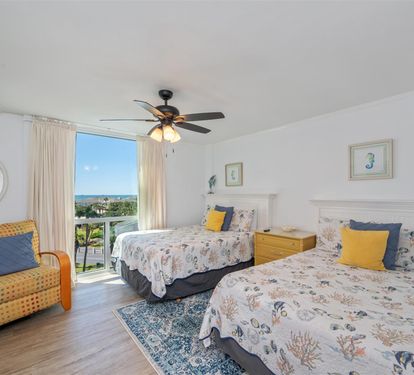 Wake up to stunning ocean views in your comfortable twin bedroom with coastal décor and refreshing ceiling fan.
