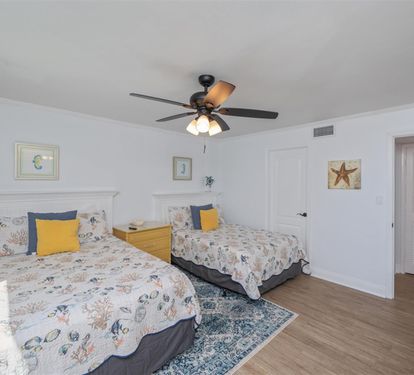 Drift off to sleep in this charming twin bedroom featuring ocean-themed bedding and coastal artwork that brings the seaside indoors.