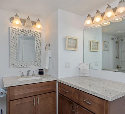 Unwind in your elegantly designed bathroom featuring rich wood vanities, marble countertops, and warm lighting that creates the perfect retreat.