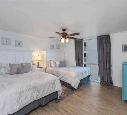 Drift off to sleep in your serene twin-bed retreat, where soft linens and gentle ceiling fan breezes create the perfect night's rest.