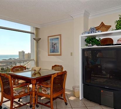 Enjoy your morning coffee at this charming dining nook while soaking in breathtaking ocean views through floor-to-ceiling windows.