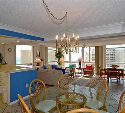 Your spacious open-concept suite invites relaxation with bright living areas, elegant chandelier lighting, and stunning city views through floor-to-ceiling windows.