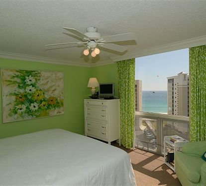 Wake up to stunning ocean views from your bright, cheerful bedroom with tropical green décor and comfortable furnishings.