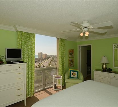 Relax in your bright bedroom with fresh green walls and a spectacular city view from your window.