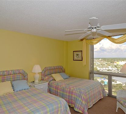 Drift off to sleep in your bright bedroom with twin beds, ceiling fan, and expansive views over the surrounding area.