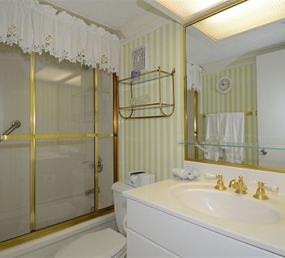 Your elegant bathroom features gold fixtures, marble counters, and classic charm for a luxurious refreshing experience.