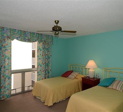 Sleep peacefully in your bright, cheerful bedroom with twin beds and cooling ceiling fan for ultimate comfort.