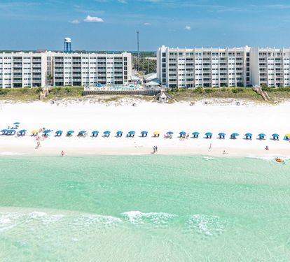 Beachfront property with direct access to pristine white sand and crystal-clear turquoise waters on Florida's Gulf Coast.