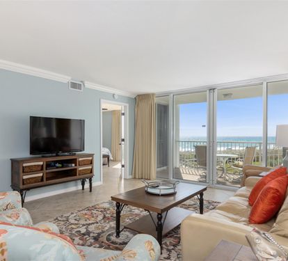 Unwind in your bright living room with ocean views, plush seating, and coastal charm perfect for relaxing after beach days.