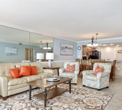 Relax in your spacious open-concept living area featuring plush seating and a fully equipped kitchen for memorable vacation moments.