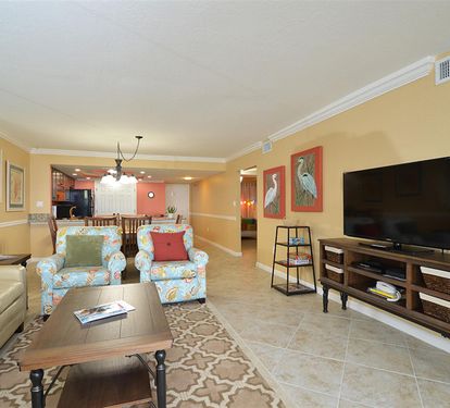 Unwind in your spacious living area with comfortable seating and large TV for cozy evenings after exploring.