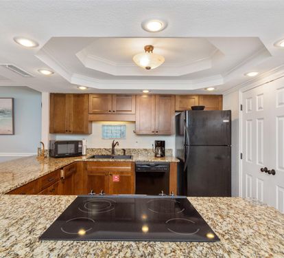 You'll love preparing meals in this fully equipped kitchen with granite countertops, modern appliances, and elegant recessed lighting throughout.