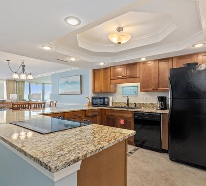 Your fully equipped kitchen features granite countertops and modern appliances, perfect for preparing meals while enjoying ocean views.