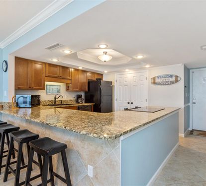 Your fully equipped kitchen features granite counters, breakfast bar seating, and everything needed to create memorable meals during your stay.