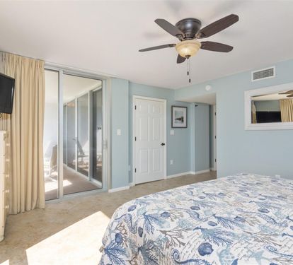 Drift off in your serene coastal bedroom with soothing sea-inspired colors and private balcony access.