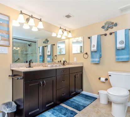 Refresh in your ocean-themed bathroom with dual sinks, elegant granite counters, and coastal blue accents that make every morning feel like a seaside getaway.