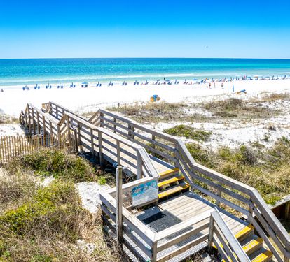 Easy beach access via boardwalk leading to pristine white sand and stunning turquoise waters, perfect for your sunny Gulf Coast getaway.