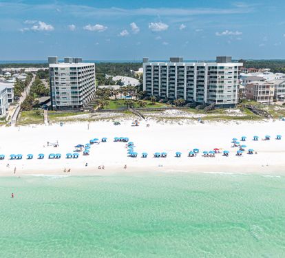 Beachfront property with direct access to pristine white sand and crystal-clear turquoise waters, offering an idyllic Gulf Coast setting in a peaceful coastal neighborhood.