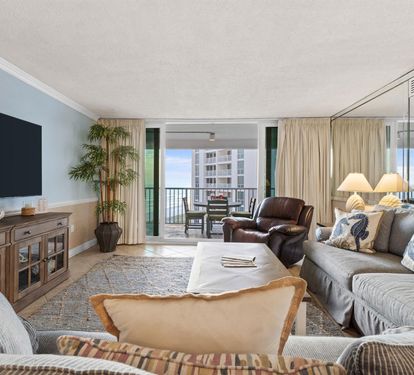 Sink into plush seating while ocean breezes drift through your private balcony doors, creating the perfect retreat for relaxation.