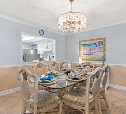 Gather around this elegant dining table where crystal chandeliers cast warm light over your memorable meals together.