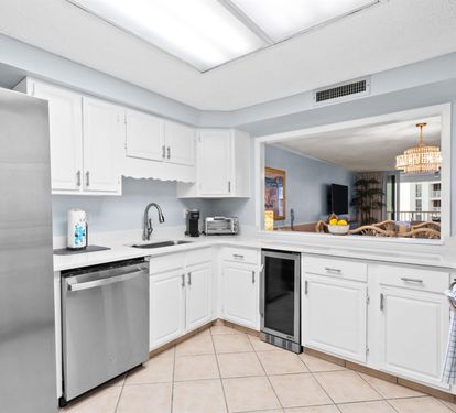 Your fully-equipped kitchen features stainless steel appliances and gleaming white cabinets, perfect for preparing meals during your stay.
