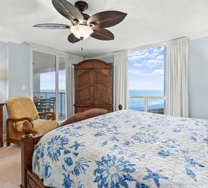 Wake up to stunning ocean views through floor-to-ceiling windows while the tropical ceiling fan keeps you perfectly cool.