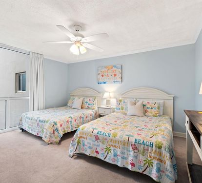Your beach-themed bedroom features twin beds with tropical decor, perfect for siblings or friends. Enjoy the coastal charm and comfort.