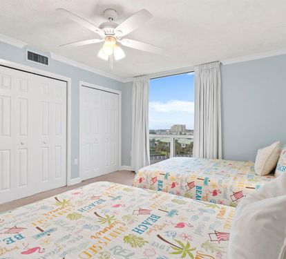 Drift off in your bright, airy bedroom with two comfortable beds, gentle ceiling fan, and peaceful city views to wake up to.