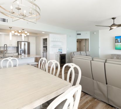 Gather around your spacious dining table while enjoying ocean views on the large screen TV in this bright, open-concept space.