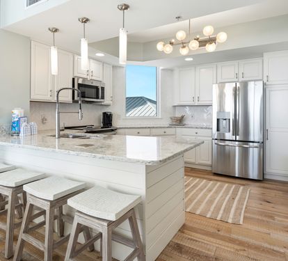 Your modern kitchen invites culinary creativity with granite counters, stainless appliances, and a bright breakfast bar perfect for morning coffee.