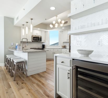 Your gourmet kitchen awaits with marble counters, stainless appliances, and coastal views perfect for memorable meals.