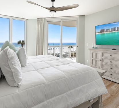 Wake up to stunning ocean views in your serene bedroom retreat, where coastal breezes and pristine white linens create the perfect sanctuary.