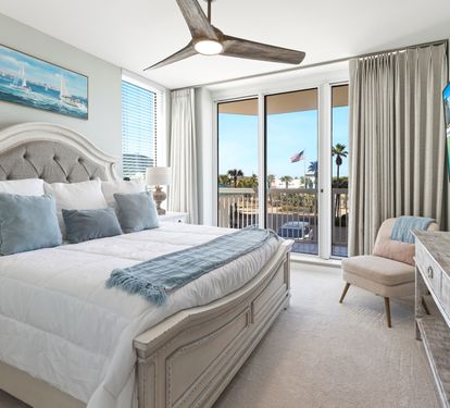 Wake up to ocean breezes in your elegant bedroom featuring a plush king bed and private balcony access with tropical views.