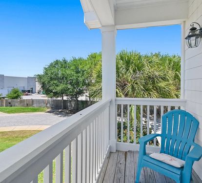 Comfortable balcony seating offers the perfect spot to unwind after a day at the beach.