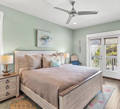 Bright and inviting primary suite featuring a king bed, private ensuite bathroom, and balcony access.