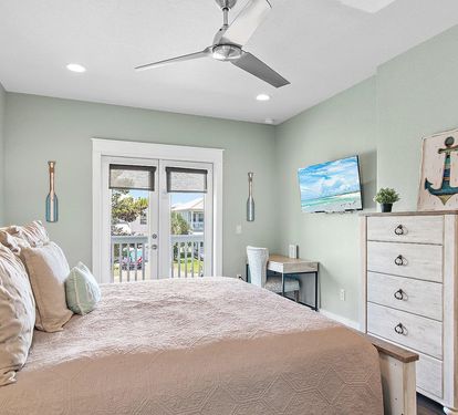 Comfortable king bed, stylish furnishings, and plenty of natural light create a relaxing retreat.