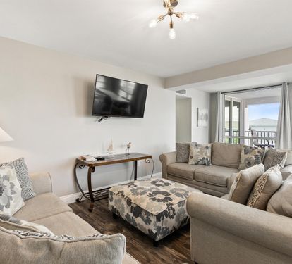 Sink into plush sofas and unwind in your spacious living room, where natural light streams through large windows.