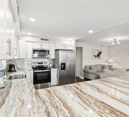 Your gorgeous marble kitchen flows seamlessly into the cozy living area, perfect for cooking and relaxing together.