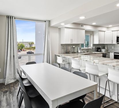 Your modern kitchen flows seamlessly with the dining area, featuring gleaming granite counters and contemporary finishes perfect for memorable meals.