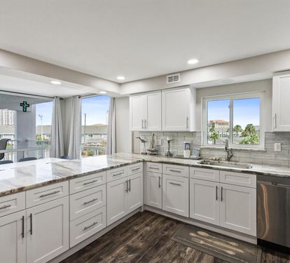 Your spacious modern kitchen features granite counters, stainless appliances, and bright windows overlooking the vibrant neighborhood below.